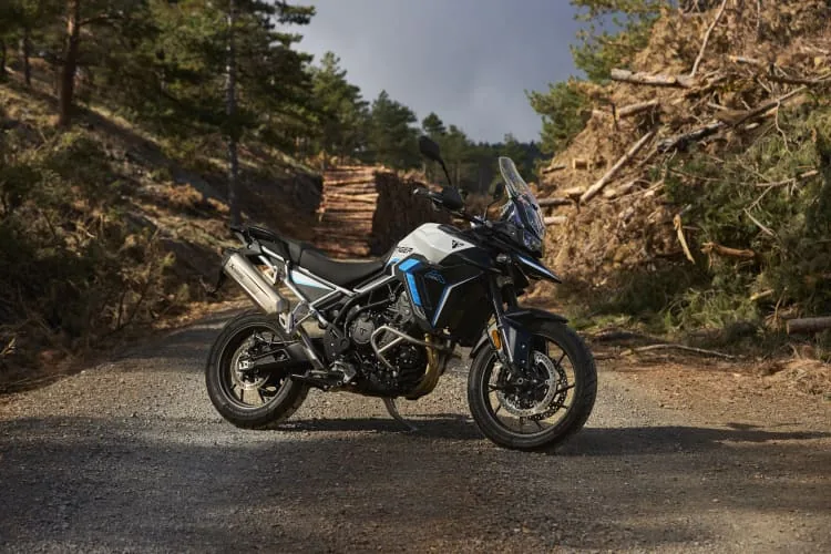 Triumph Tiger 900 Alpine Edition in Snowdonia White parked on a forest gravel road