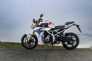 2027 BMW F 450 R M Sport in Snaefell White side profile on a country road under grey skies, showing the white tubular steel frame, gold KYB fork and M Motorsport rim stickers