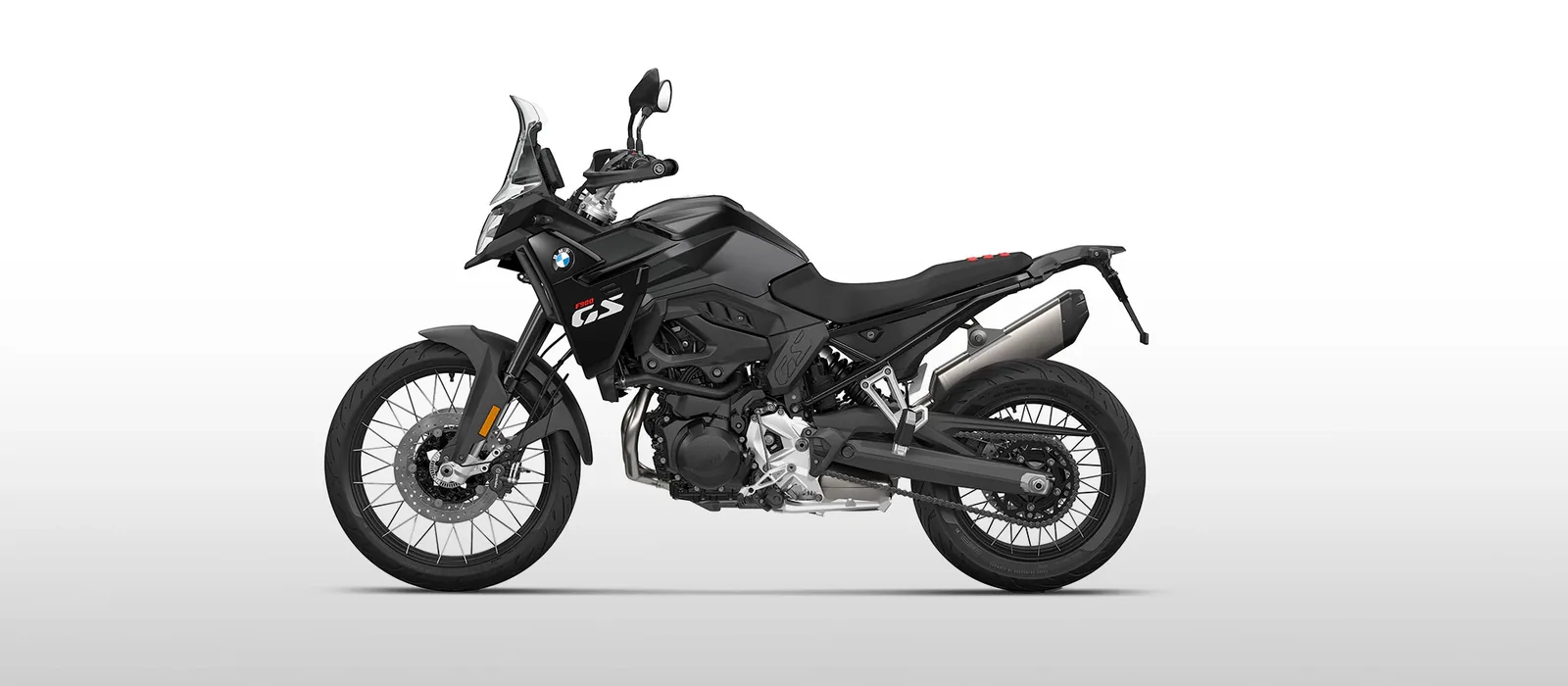 Studio side view of the BMW F 900 GS in Blackstorm metallic with a black frame and black spoked wheels