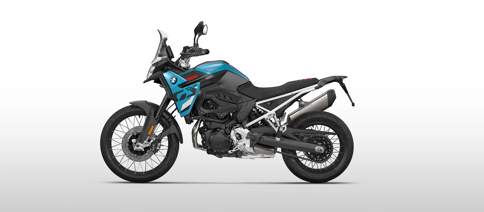 Studio side view of the BMW F 900 GS in blue and black with a white frame and black spoked wheels