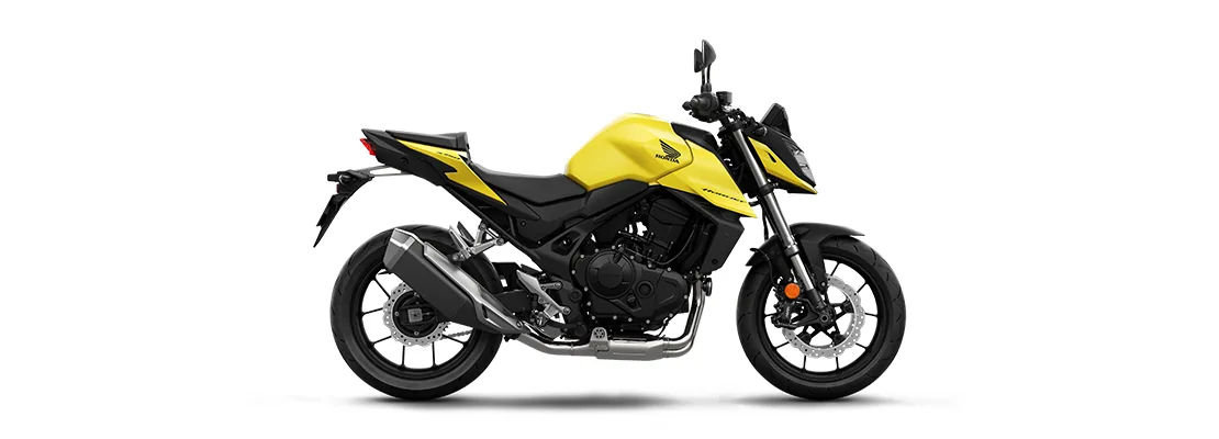 Studio side profile of the Honda CB750 Hornet in Mat Goldfinch Yellow with a black frame, gold fork and short two-into-one exhaust