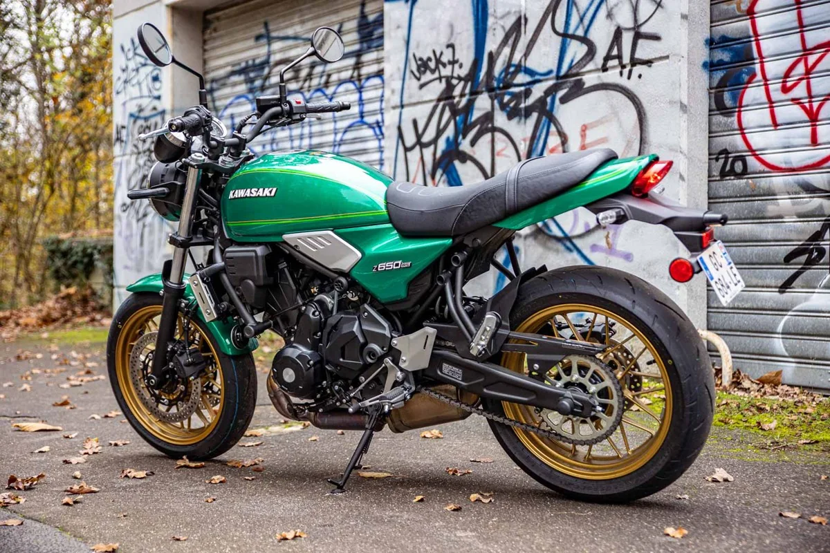 Rear three-quarter view of the green Kawasaki Z650RS showing the ducktail, round LED tail light and gold rear wheel