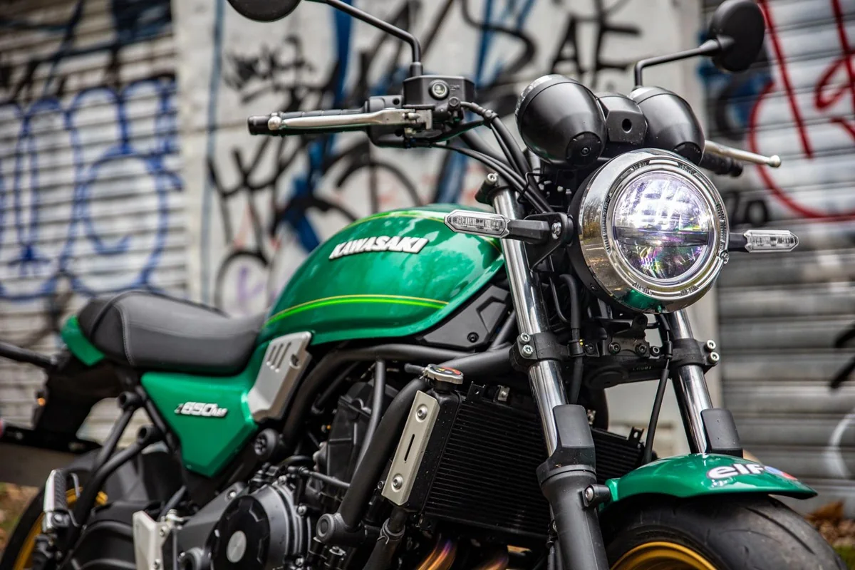 Close-up of the Kawasaki Z650RS round LED headlight with chrome rim, slim LED indicators and green tank behind