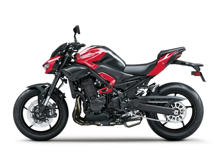 Left side profile of the 2026 Kawasaki Z900 ABS in Candy Persimmon Red and black with the steel trellis frame, inline four engine, 41 mm upside-down fork and twin front discs