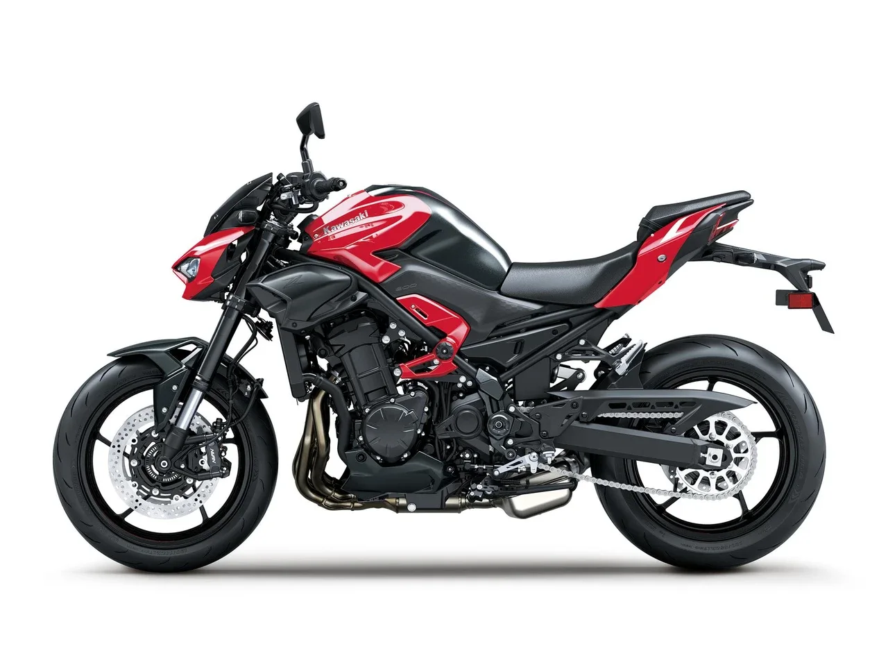 Left side profile of the 2026 Kawasaki Z900 ABS in Candy Persimmon Red and black with the steel trellis frame, inline four engine, 41 mm upside-down fork and twin front discs