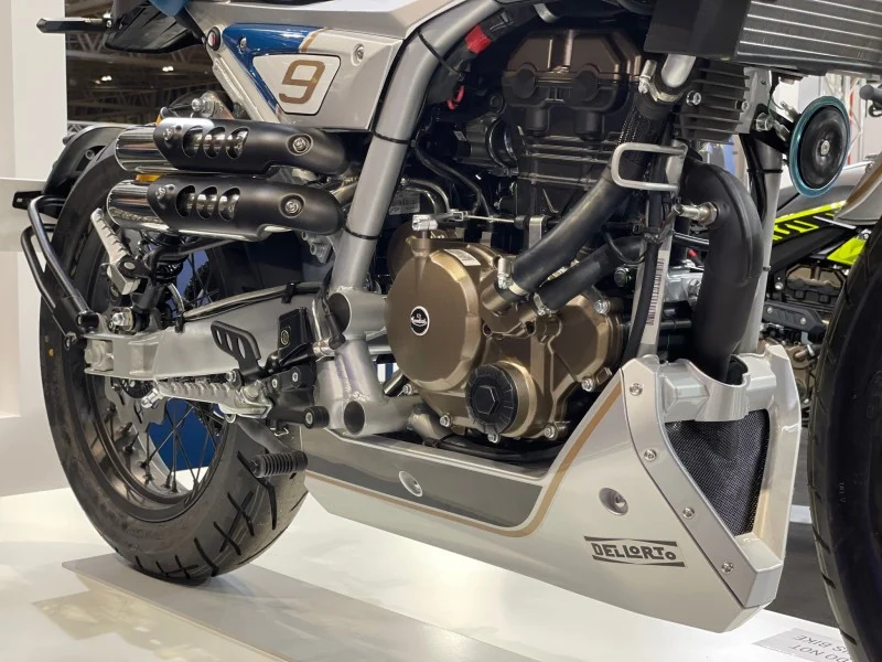 Low view of the Mondial HPS 125 Ubbiali engine, Dell'Orto bash plate, swingarm, footrest and twin exhausts on a show stand