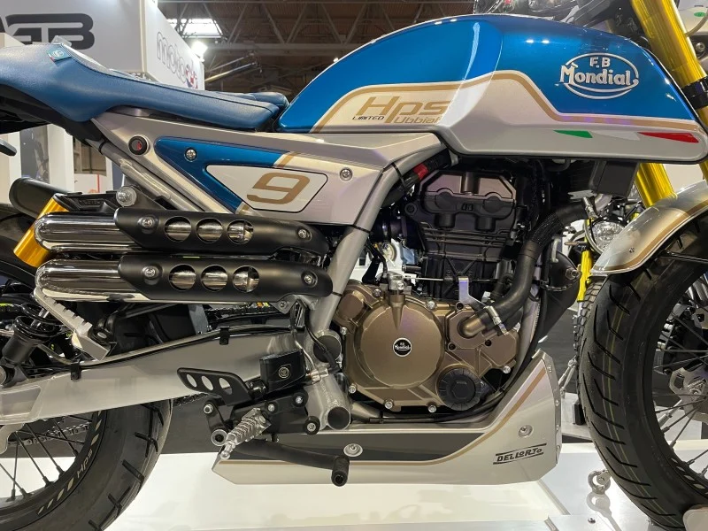 Side view of the Mondial HPS 125 Ubbiali engine and twin shotgun exhausts with perforated heat shields, number 9 side plate and HPS Limited Ubbiali tank graphics