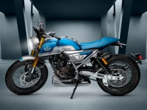 Left side profile of the Mondial HPS 125 Ubbiali Limited in a studio, showing the light blue tank, silver side plate with number 9, gold upside-down fork, twin shotgun exhausts, quilted blue seat and spoked wheels